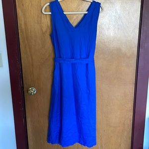 Linen blue midi length dress. Tie around the waist. Zip back.